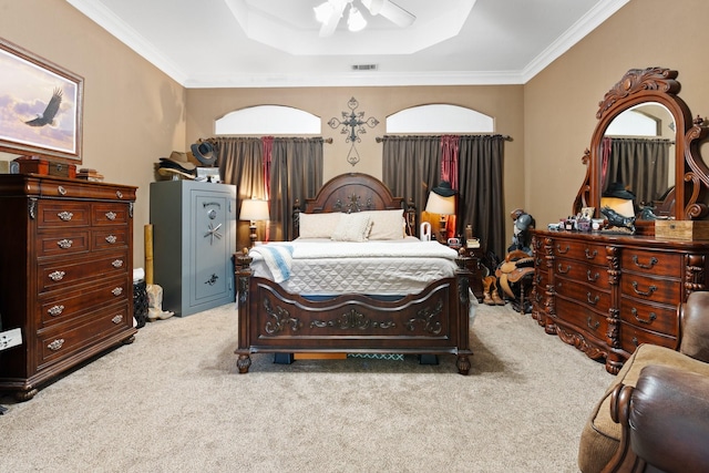 carpeted bedroom with a raised ceiling, ceiling fan, and ornamental molding