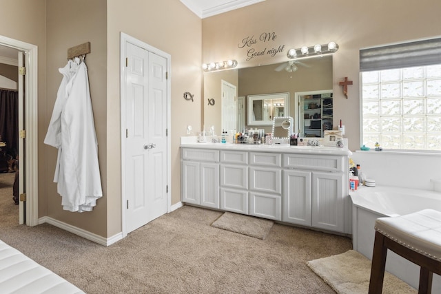 bathroom with vanity, a bathtub, crown molding, and ceiling fan