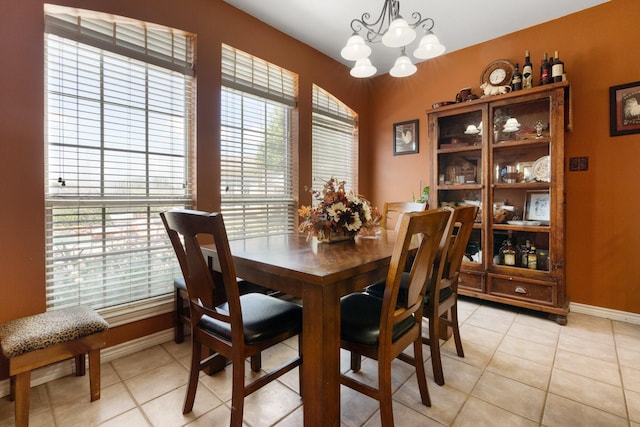 tiled dining area with a wealth of natural light and a chandelier