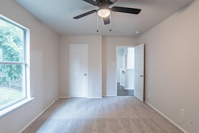 unfurnished bedroom with ceiling fan and light carpet