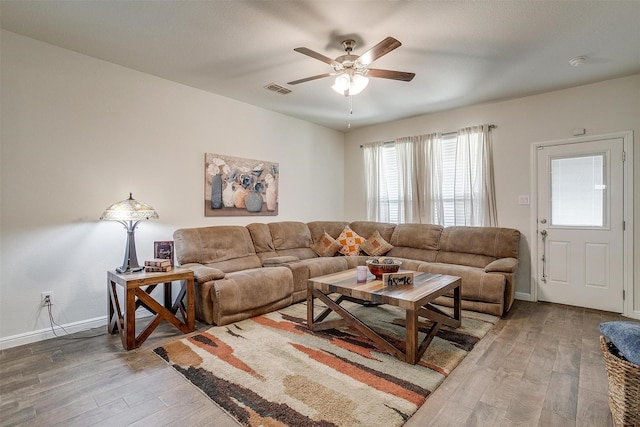 living room with wood-type flooring and ceiling fan