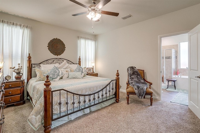 bedroom with light carpet, connected bathroom, and ceiling fan