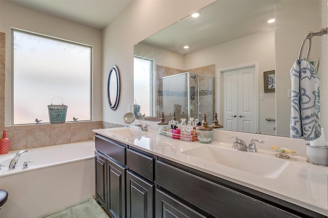 bathroom with tile patterned floors, vanity, and shower with separate bathtub