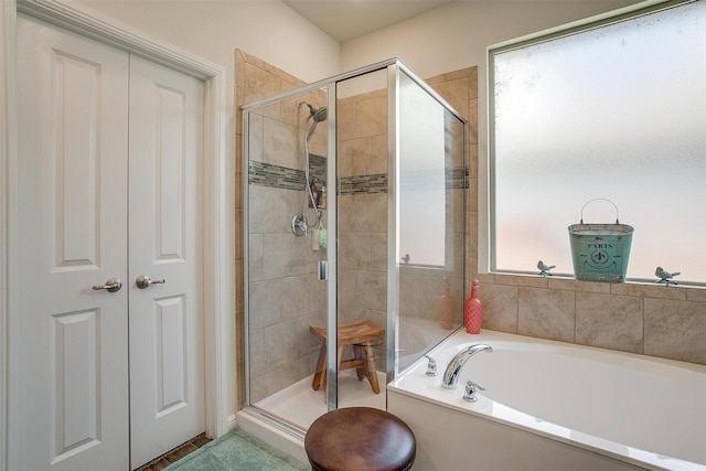 bathroom with separate shower and tub