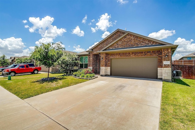 view of front of house with a front lawn, a garage, and central AC