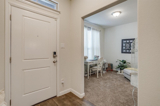 foyer with dark colored carpet