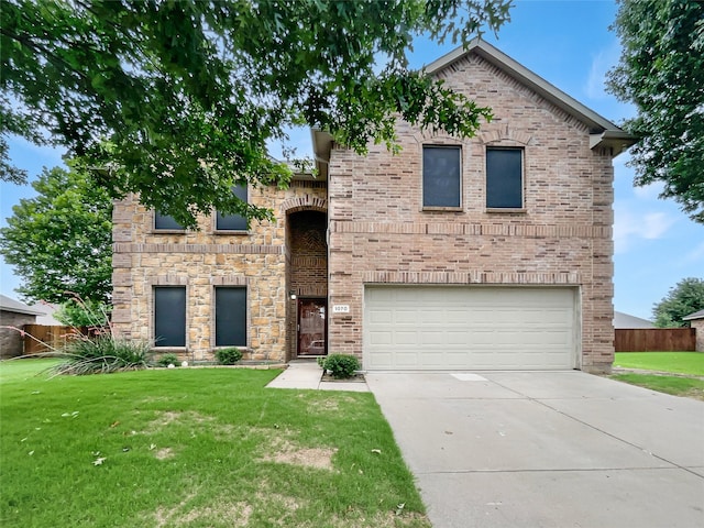 view of front facade featuring a garage and a front yard