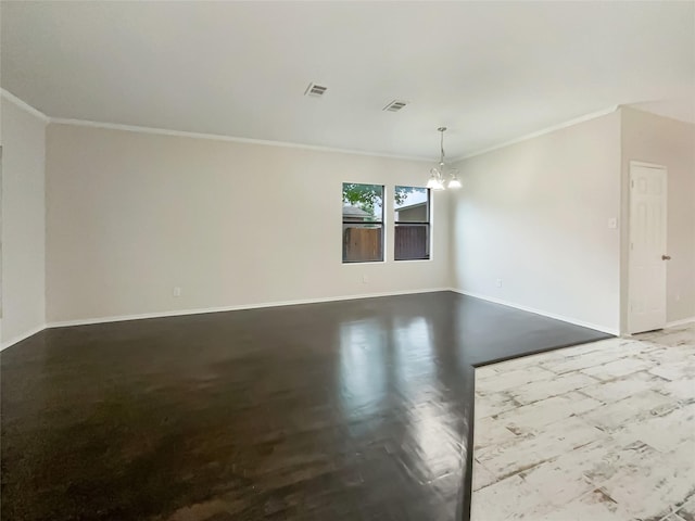 spare room with ornamental molding and a notable chandelier