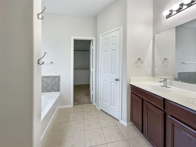 bathroom featuring vanity, a tub, and tile patterned floors