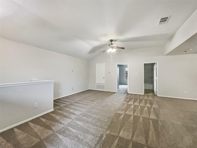 spare room featuring vaulted ceiling, ceiling fan, and dark carpet