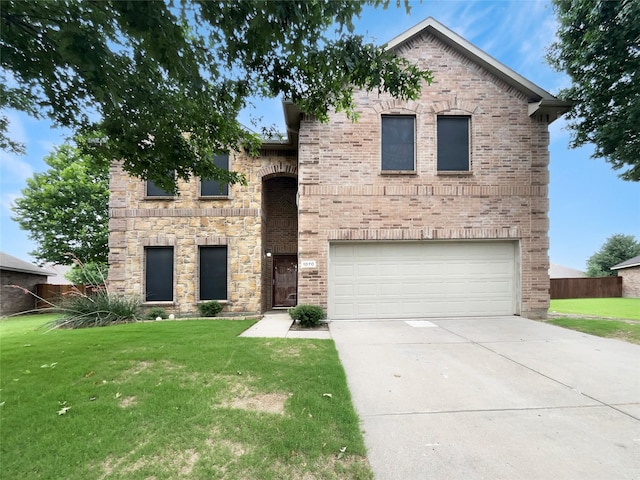 view of front facade with a garage and a front lawn