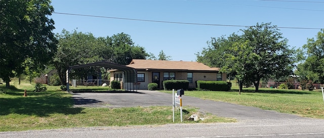 view of front of house with a front lawn and a carport