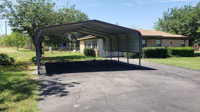 view of car parking featuring a carport and a lawn