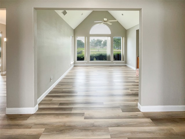 interior space with light wood-type flooring, vaulted ceiling, and ceiling fan