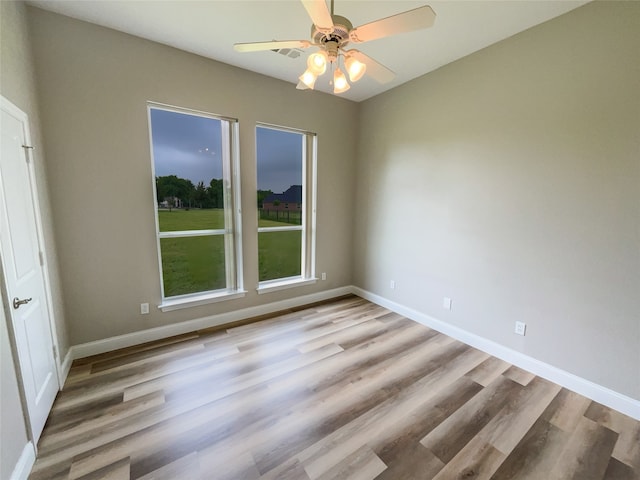 empty room featuring ceiling fan and light hardwood / wood-style flooring