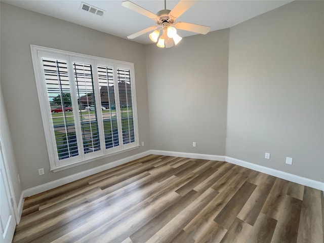 unfurnished room with ceiling fan and hardwood / wood-style flooring