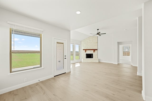 unfurnished living room featuring a fireplace, light wood-type flooring, and plenty of natural light