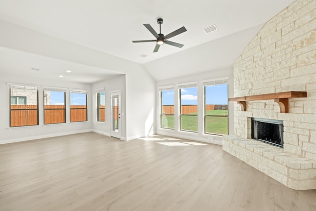 unfurnished living room with lofted ceiling, light wood-type flooring, and plenty of natural light