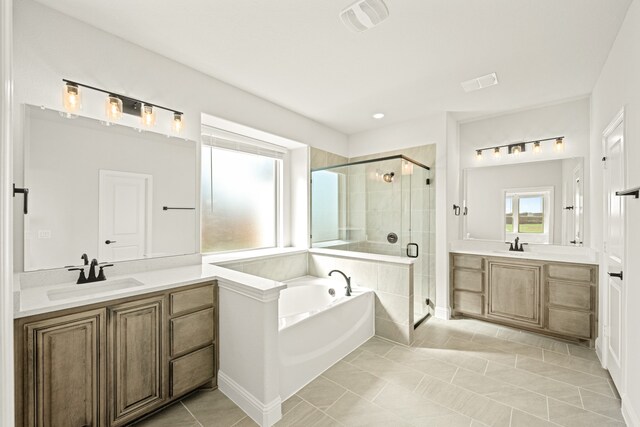 bathroom featuring vanity, independent shower and bath, and tile patterned flooring