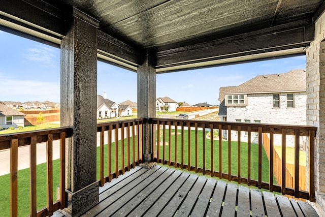 wooden terrace featuring a lawn