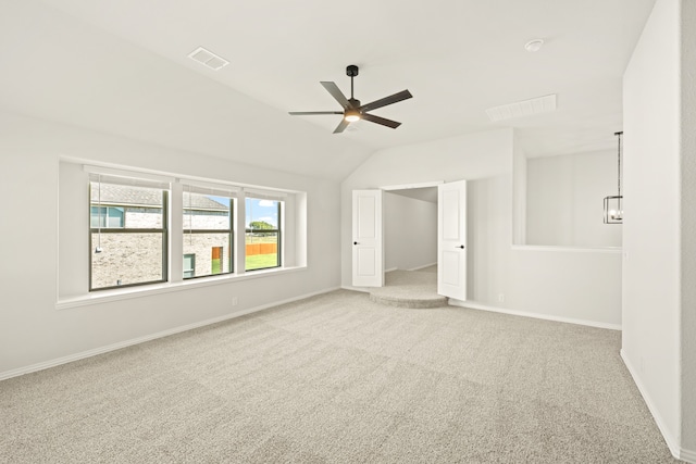 unfurnished room with lofted ceiling, light colored carpet, and ceiling fan