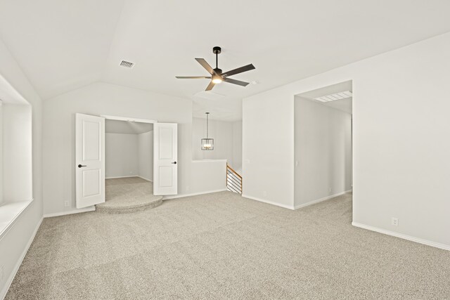 additional living space with lofted ceiling, light colored carpet, and ceiling fan