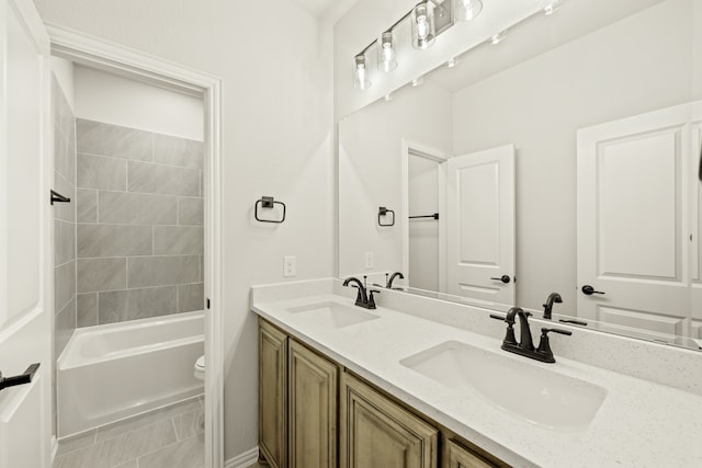 full bathroom featuring tiled shower / bath, vanity, and toilet