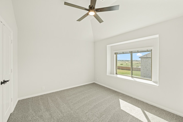 carpeted empty room with vaulted ceiling and ceiling fan