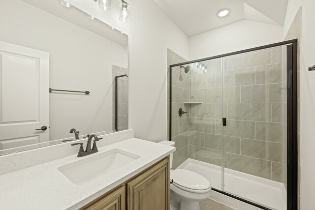 bathroom featuring toilet, a shower with shower door, baseboard heating, and vanity