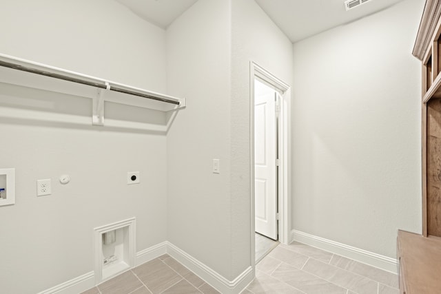 laundry area with gas dryer hookup, hookup for an electric dryer, hookup for a washing machine, and light tile patterned floors