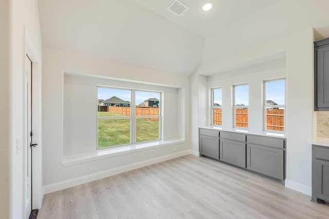 interior space featuring light hardwood / wood-style flooring and vaulted ceiling