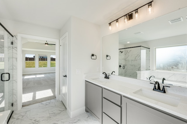 bathroom with ceiling fan, a shower with door, and vanity