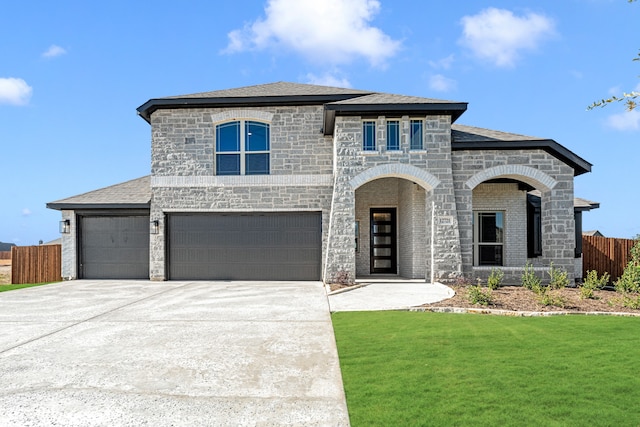 view of front facade featuring a garage and a front lawn