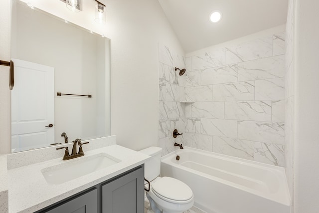 full bathroom with vanity, tiled shower / bath combo, toilet, and lofted ceiling