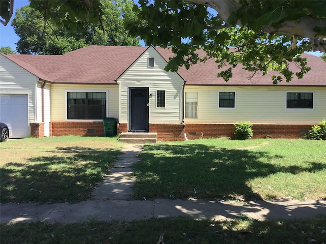 view of front of property with a garage and a front yard