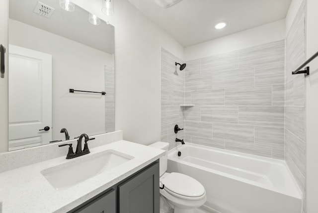 full bathroom with vanity, toilet, and tiled shower / bath