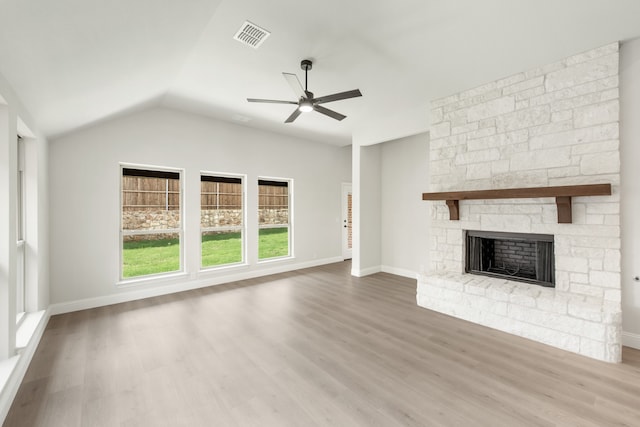 unfurnished living room featuring wood-type flooring, a fireplace, vaulted ceiling, and ceiling fan