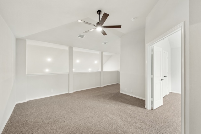 carpeted empty room with vaulted ceiling and ceiling fan