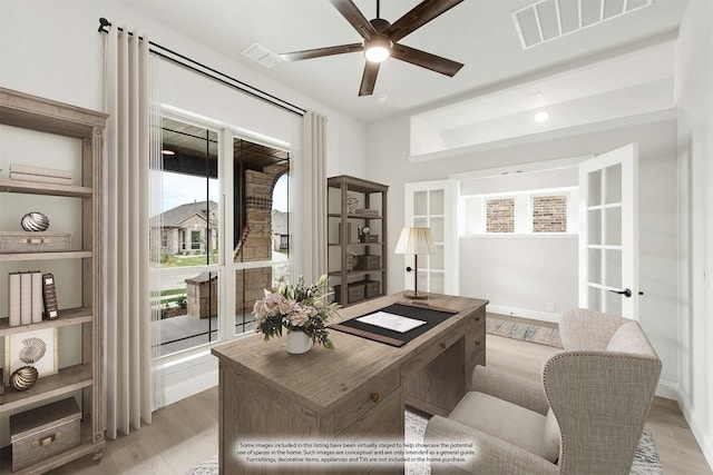 home office with ceiling fan, light hardwood / wood-style flooring, and plenty of natural light