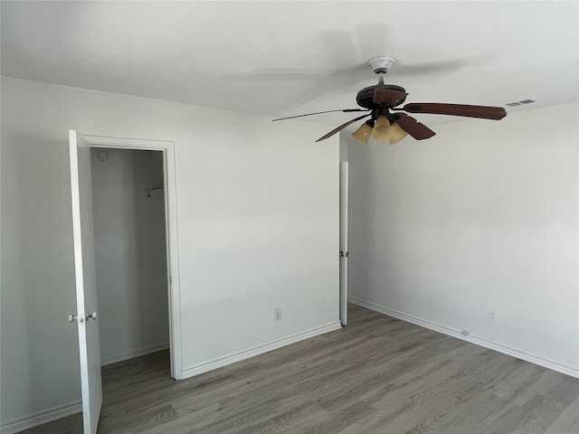 unfurnished bedroom featuring hardwood / wood-style floors and ceiling fan