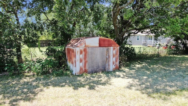 view of outbuilding with a yard