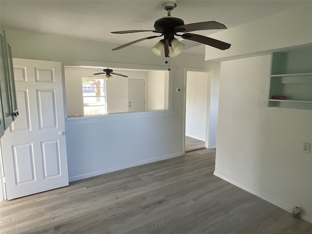 unfurnished room featuring ceiling fan and hardwood / wood-style flooring