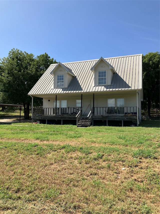 back of property featuring a lawn and a wooden deck