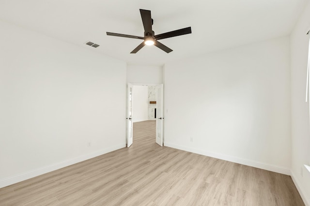 spare room featuring ceiling fan and light hardwood / wood-style flooring