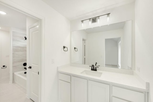 bathroom featuring tile patterned flooring, vanity, and tiled shower / bath combo