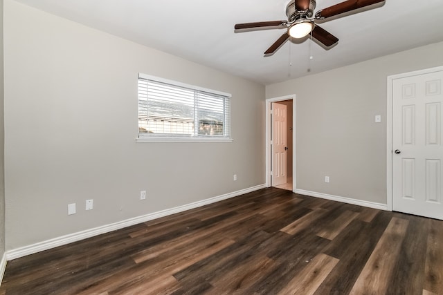 empty room with dark hardwood / wood-style floors and ceiling fan