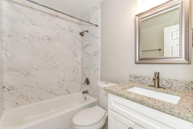 full bathroom featuring toilet, large vanity, and tiled shower / bath