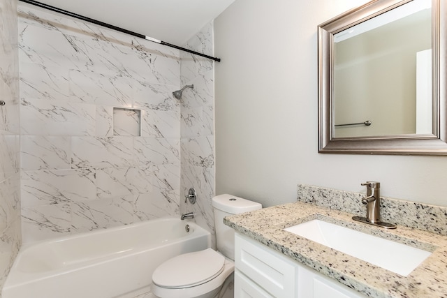 full bathroom with large vanity, tiled shower / bath, and toilet