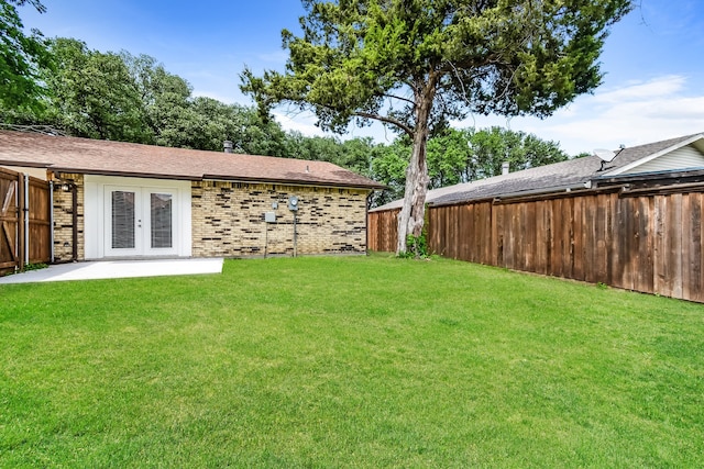 view of yard featuring a patio area and french doors