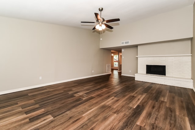 unfurnished living room featuring dark hardwood / wood-style floors, high vaulted ceiling, ceiling fan, and a fireplace